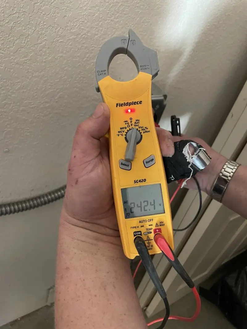 Voltage testing with clamp meter during Whole House Surge Protector in Navy